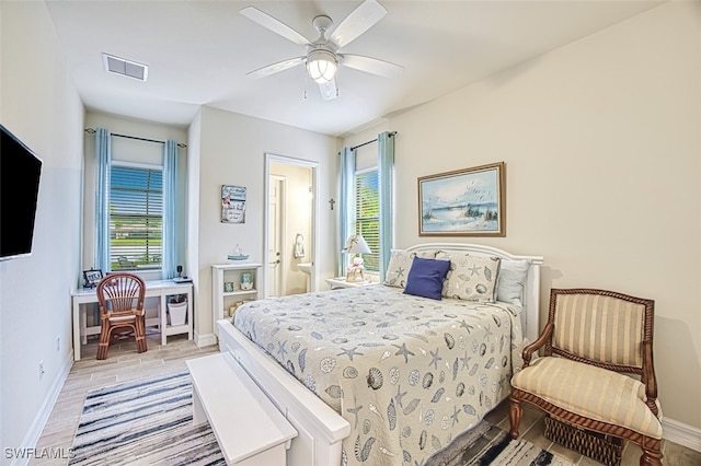 bedroom with visible vents, multiple windows, and baseboards