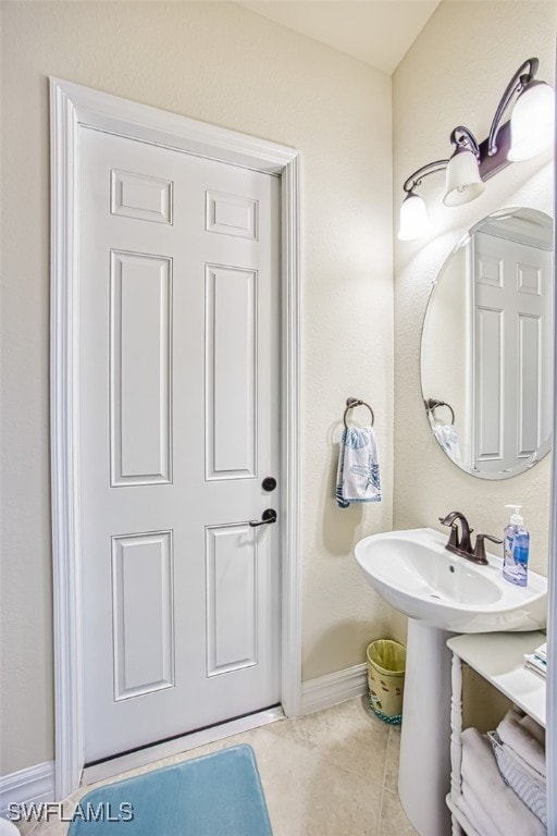 bathroom featuring tile patterned flooring and baseboards