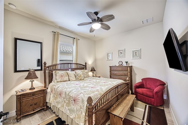 bedroom featuring a ceiling fan, light wood-style floors, baseboards, and visible vents