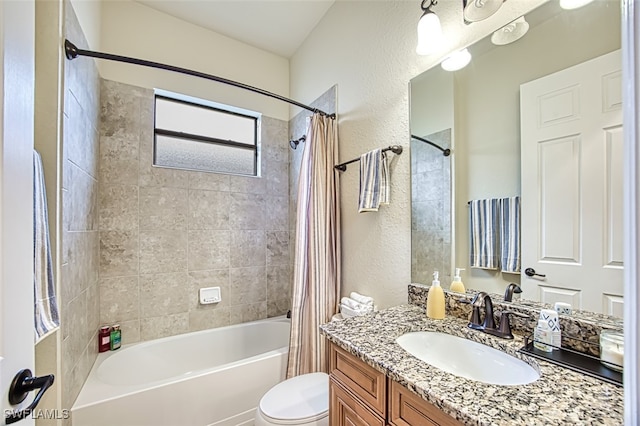 bathroom featuring shower / bath combo with shower curtain, toilet, vanity, and a textured wall