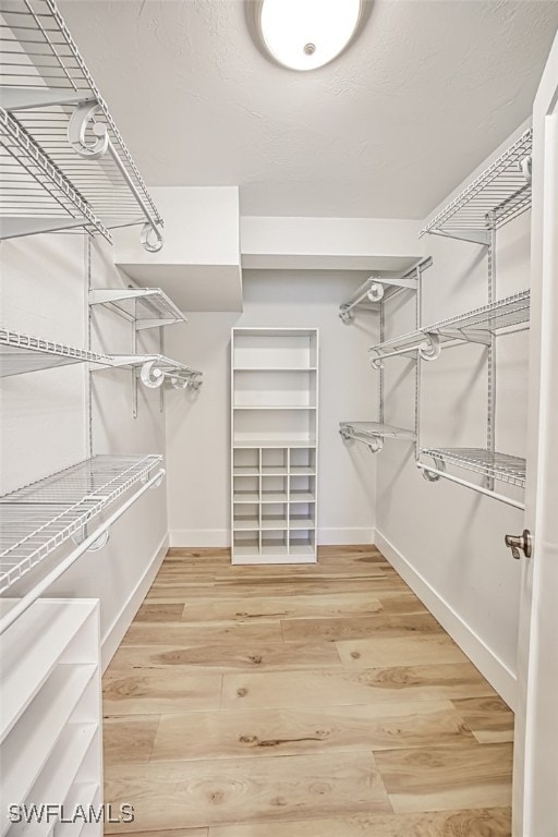 spacious closet with light wood-style floors