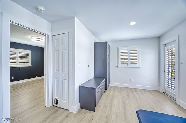 interior space with light wood-type flooring, baseboards, and recessed lighting