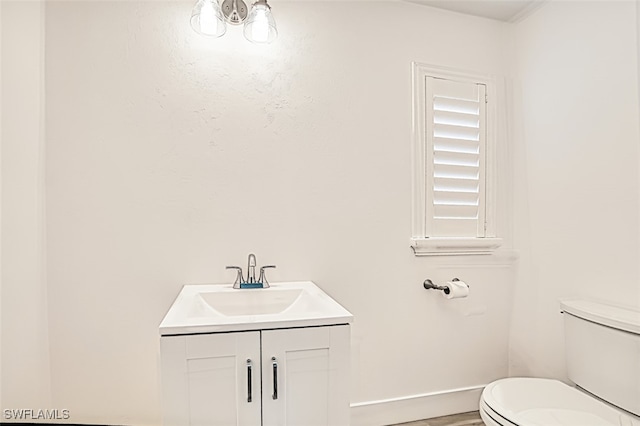 bathroom featuring toilet and vanity