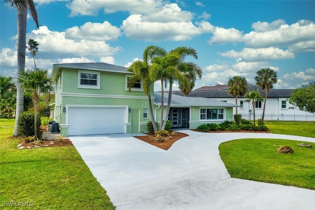 view of front of home with driveway, a front lawn, and stucco siding