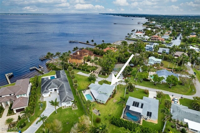 drone / aerial view featuring a residential view and a water view