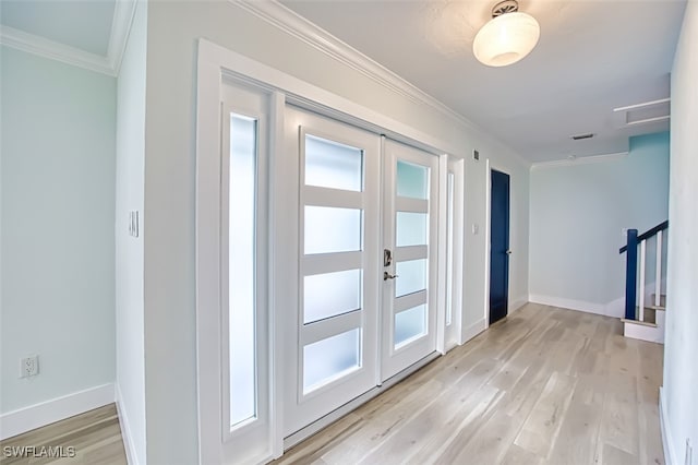 entryway with baseboards, french doors, light wood-style floors, and crown molding