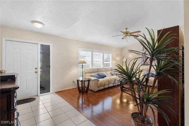 entrance foyer with ceiling fan, baseboards, and wood finished floors