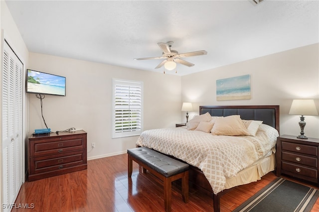 bedroom featuring a closet, ceiling fan, baseboards, and wood finished floors