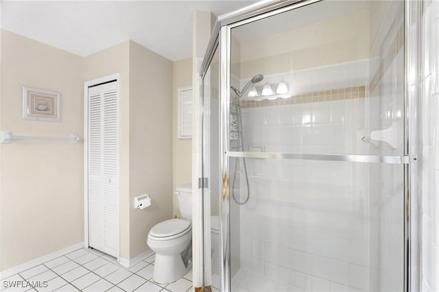 full bathroom with baseboards, tile patterned flooring, toilet, and a shower stall