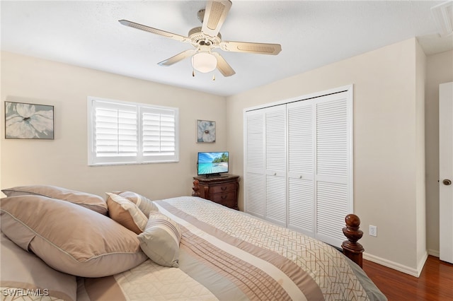 bedroom featuring ceiling fan, baseboards, a closet, and wood finished floors