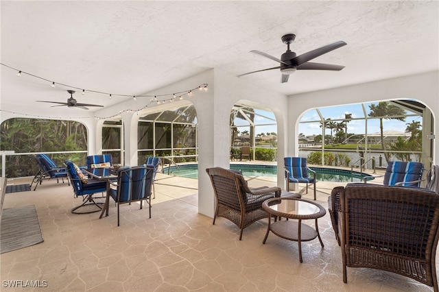 sunroom / solarium with a pool and ceiling fan