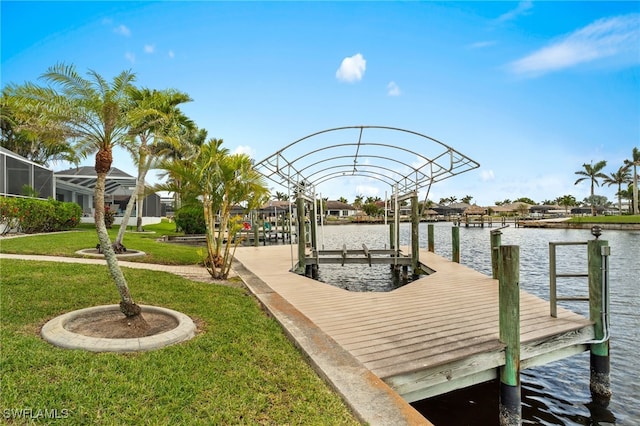 view of dock with a yard, a water view, and boat lift