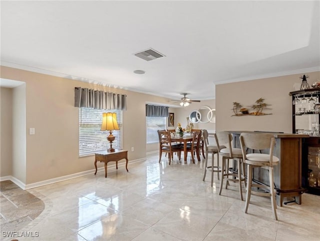 dining area with visible vents, ceiling fan, baseboards, ornamental molding, and marble finish floor