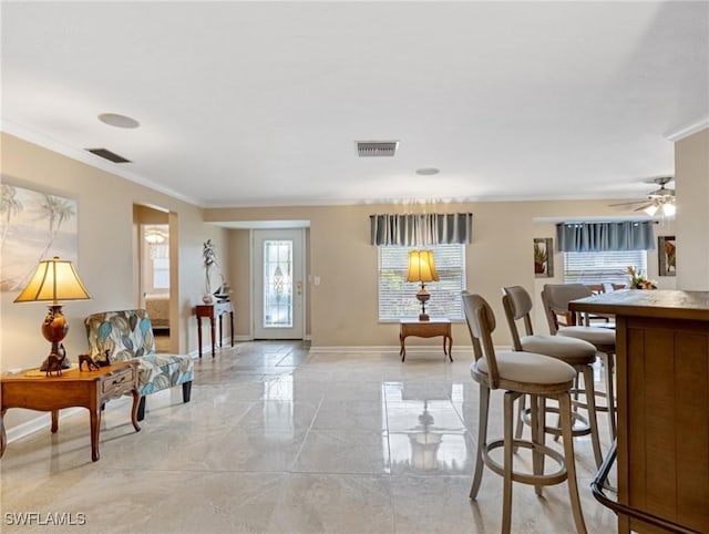 interior space with visible vents, baseboards, marble finish floor, and ornamental molding