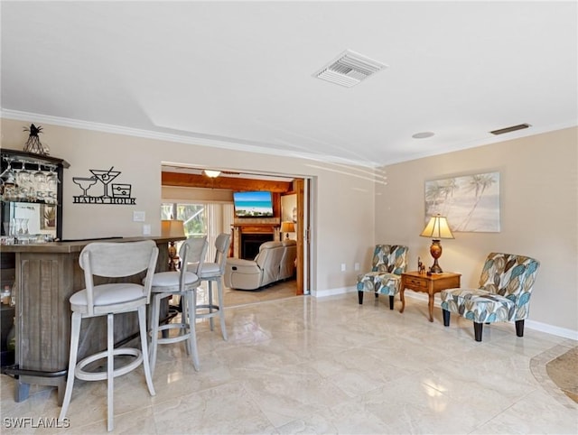 interior space with visible vents, baseboards, a bar, and crown molding