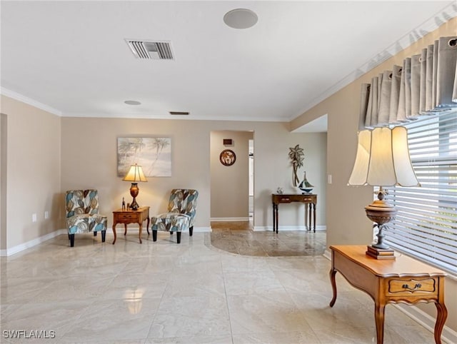 living area with visible vents, baseboards, and ornamental molding