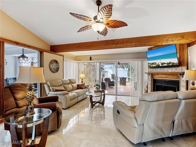 living area with ceiling fan, a fireplace, and vaulted ceiling with beams