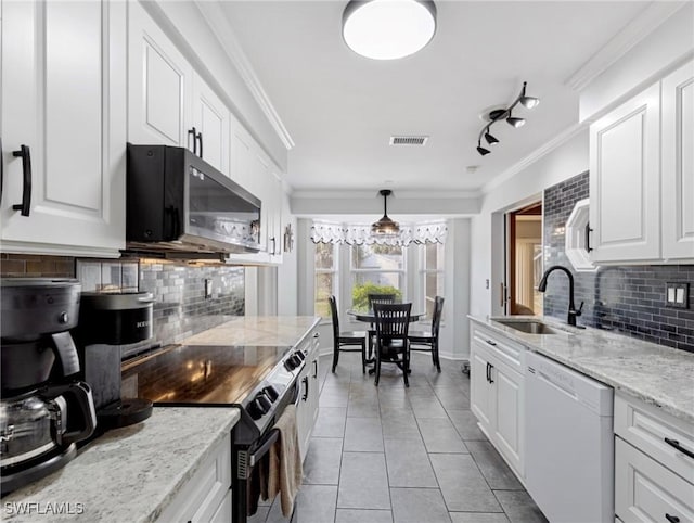 kitchen featuring visible vents, white dishwasher, a sink, electric stove, and crown molding