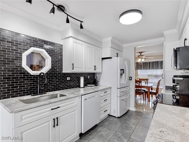 kitchen featuring a sink, tasteful backsplash, white appliances, white cabinets, and crown molding