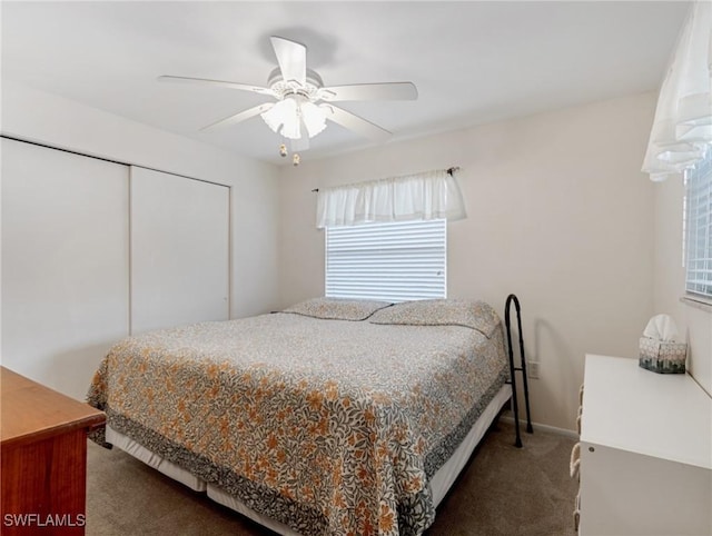 carpeted bedroom featuring a ceiling fan, a closet, and baseboards