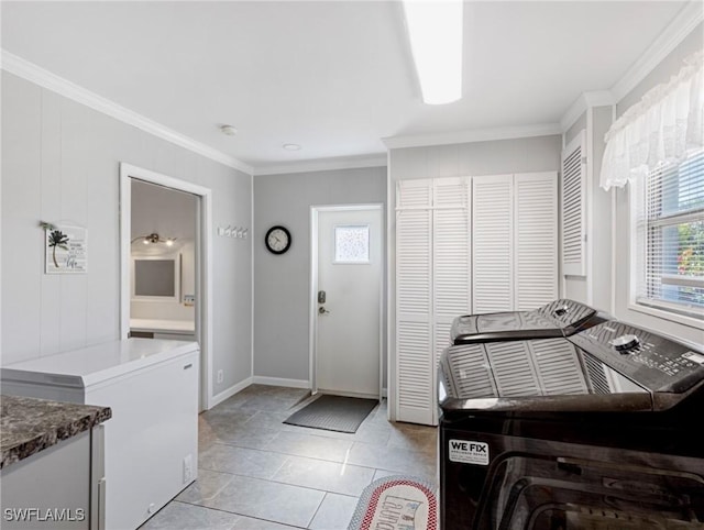 laundry room with washing machine and dryer, baseboards, and ornamental molding