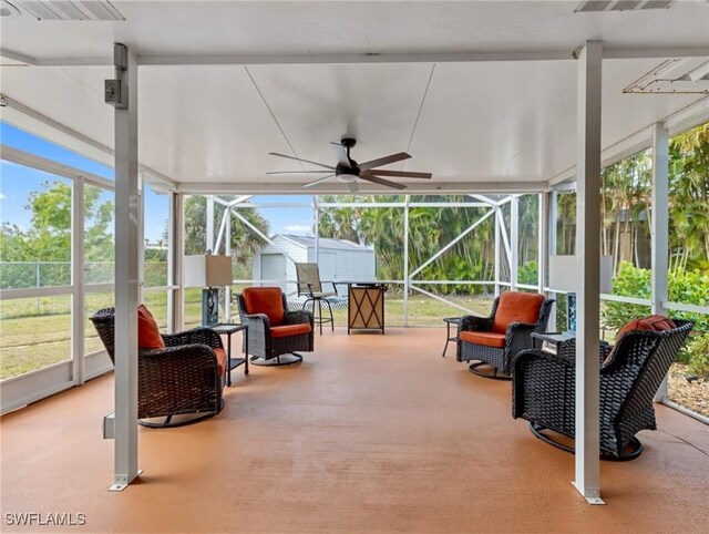 sunroom with plenty of natural light, visible vents, and a ceiling fan