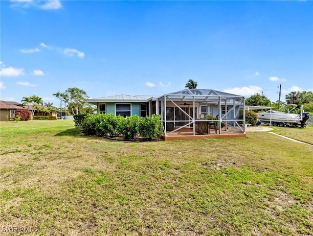 view of front of house with a lanai and a front yard