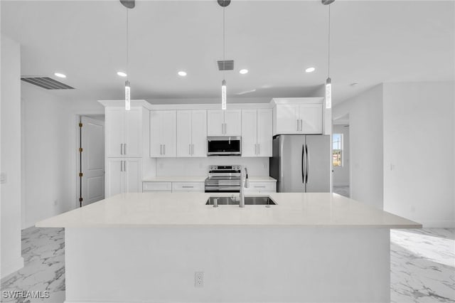 kitchen with visible vents, an island with sink, marble finish floor, stainless steel appliances, and a sink