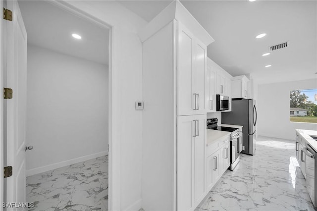 kitchen featuring marble finish floor, stainless steel appliances, recessed lighting, visible vents, and white cabinets