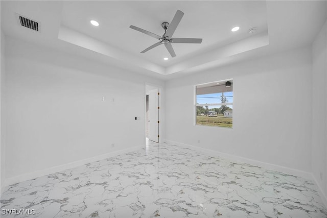 unfurnished room featuring recessed lighting, visible vents, baseboards, marble finish floor, and a raised ceiling