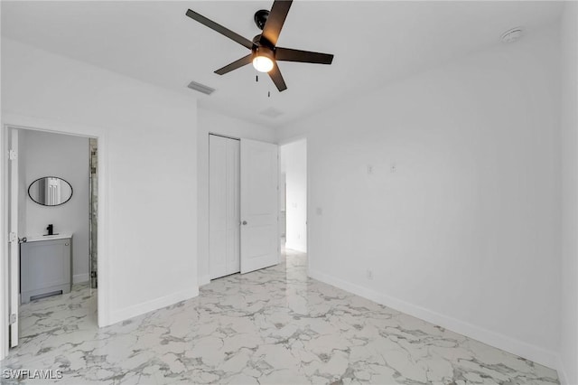 unfurnished bedroom with connected bathroom, visible vents, baseboards, marble finish floor, and a closet