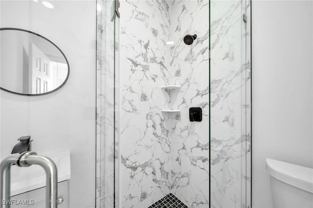 full bathroom with toilet and a marble finish shower