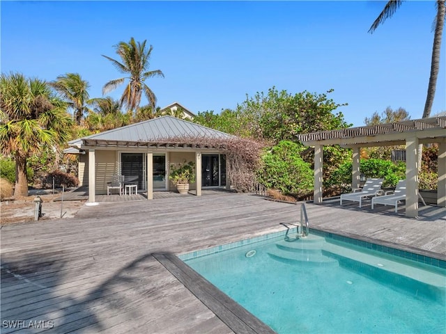 view of pool with a wooden deck and a pergola