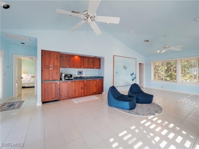 kitchen featuring dark countertops, ceiling fan, open floor plan, and light tile patterned flooring