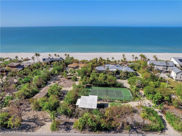 drone / aerial view with a water view and a beach view