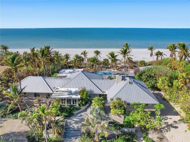 birds eye view of property featuring a water view and a view of the beach