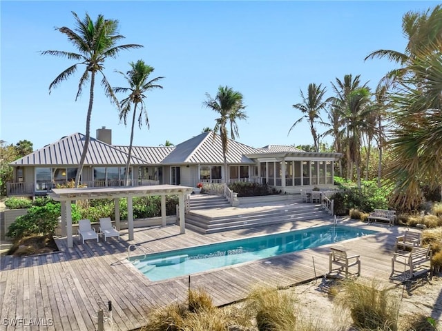 community pool with a deck and a sunroom