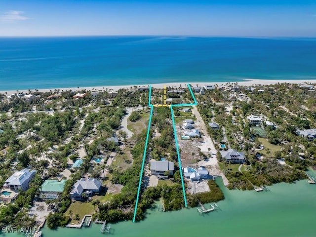 birds eye view of property featuring a view of the beach and a water view