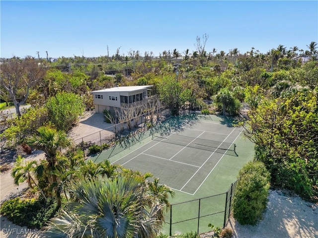 view of sport court featuring fence