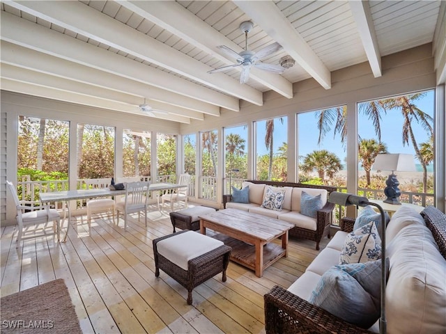 sunroom with plenty of natural light, beam ceiling, and a ceiling fan