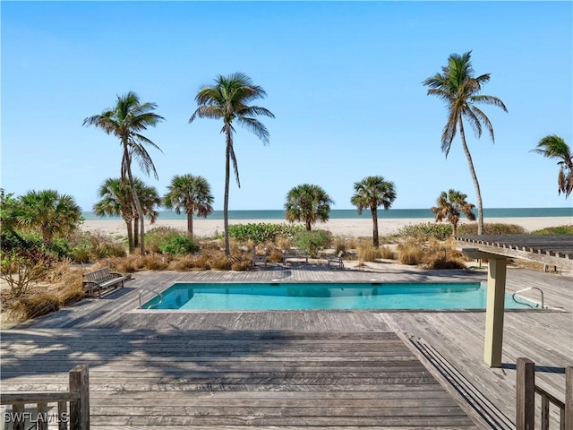 outdoor pool with a deck with water view