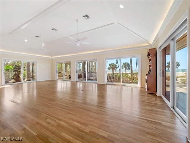 unfurnished living room with a healthy amount of sunlight, light wood-style flooring, and visible vents