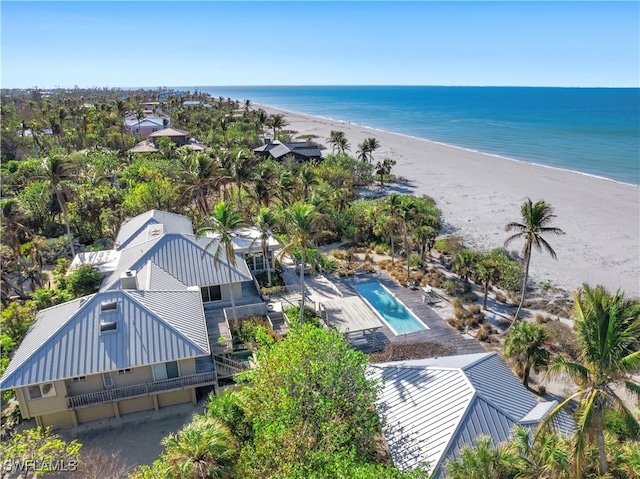 bird's eye view with a water view and a beach view