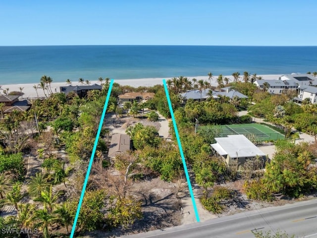 bird's eye view featuring a view of the beach and a water view