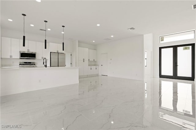 unfurnished living room with recessed lighting, marble finish floor, visible vents, and french doors