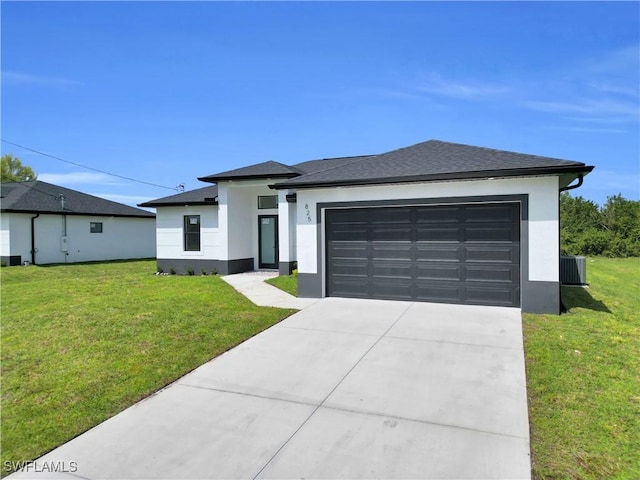 view of front of property featuring a front lawn, a garage, driveway, and stucco siding