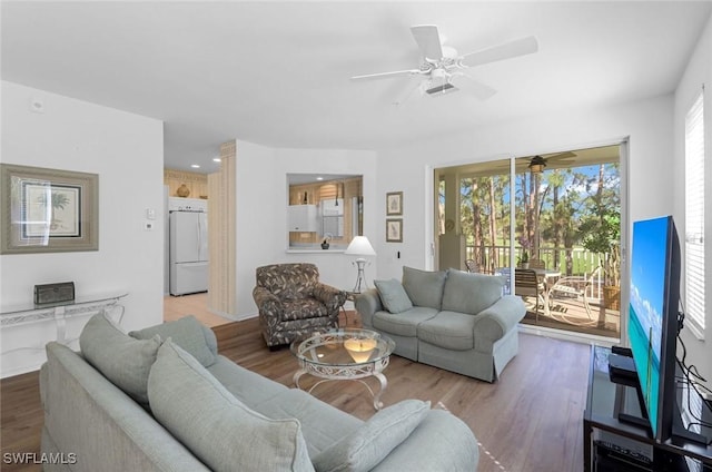 living room featuring a ceiling fan and wood finished floors