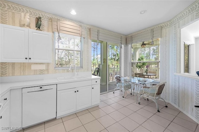 kitchen featuring a sink, white cabinetry, light tile patterned flooring, white dishwasher, and light countertops