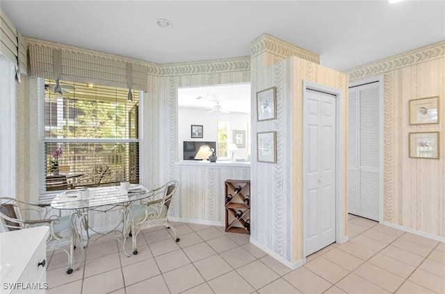 dining area featuring tile patterned floors, ceiling fan, wallpapered walls, and baseboards