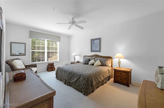 bedroom with a ceiling fan and carpet